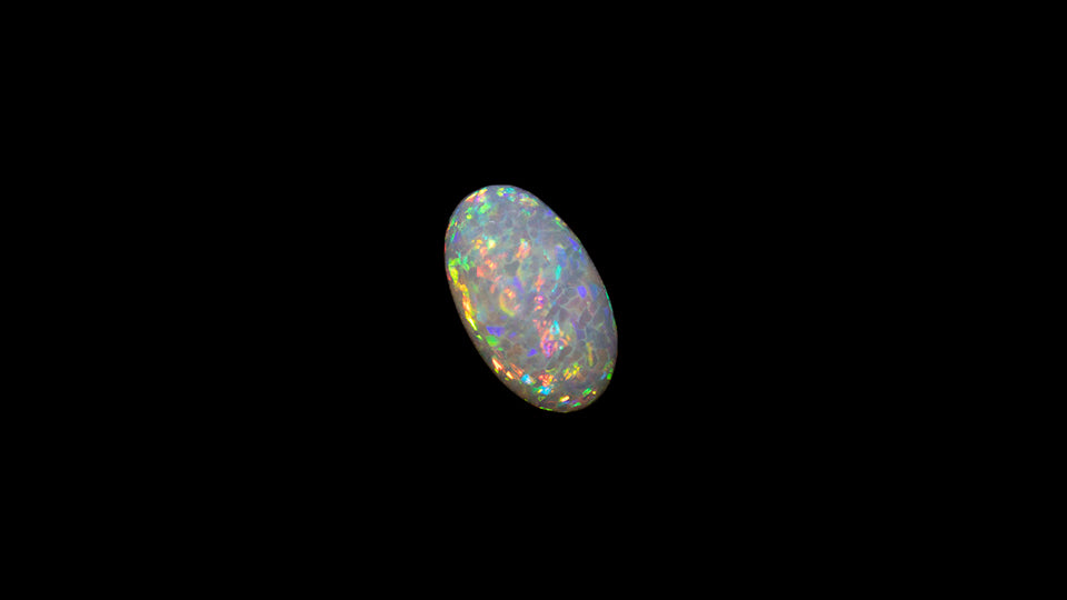 8.5 carat rare and unusual wavey honeycomb pattern Welo Ethiopia oval shaped cabochon.